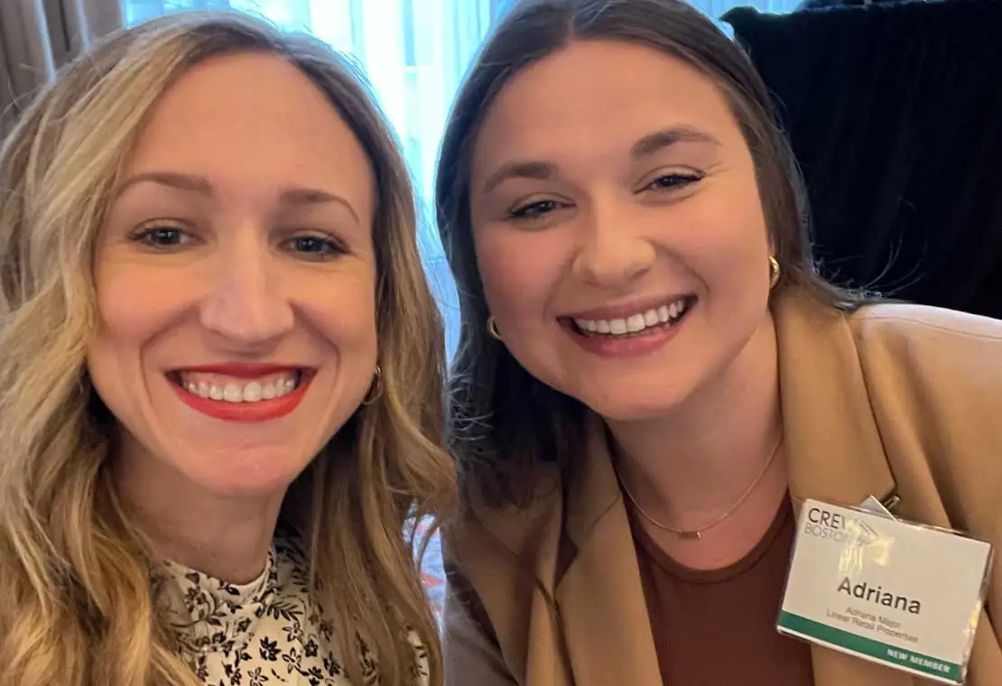 Two women smiling towards the camera