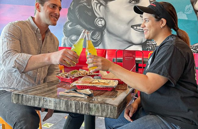 Photo of Jared celebrating with tenant at California Burritos