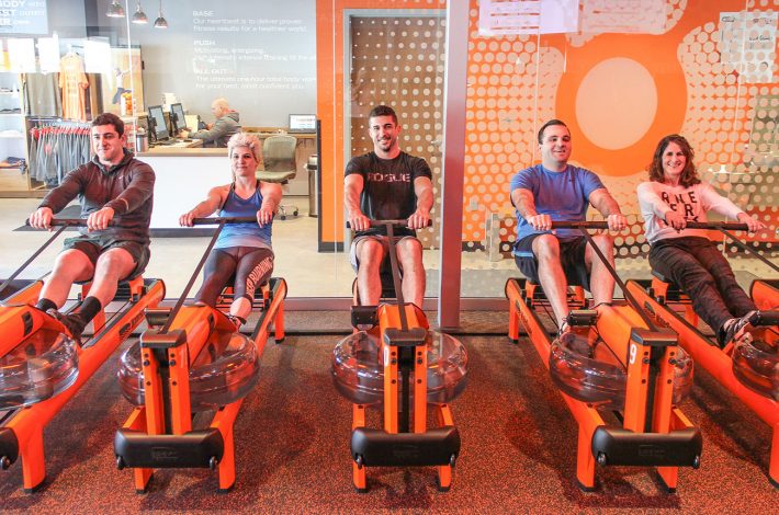 Linear Retail employees with Orangetheory staff on the rowing machines at Orangetheory, Manchester