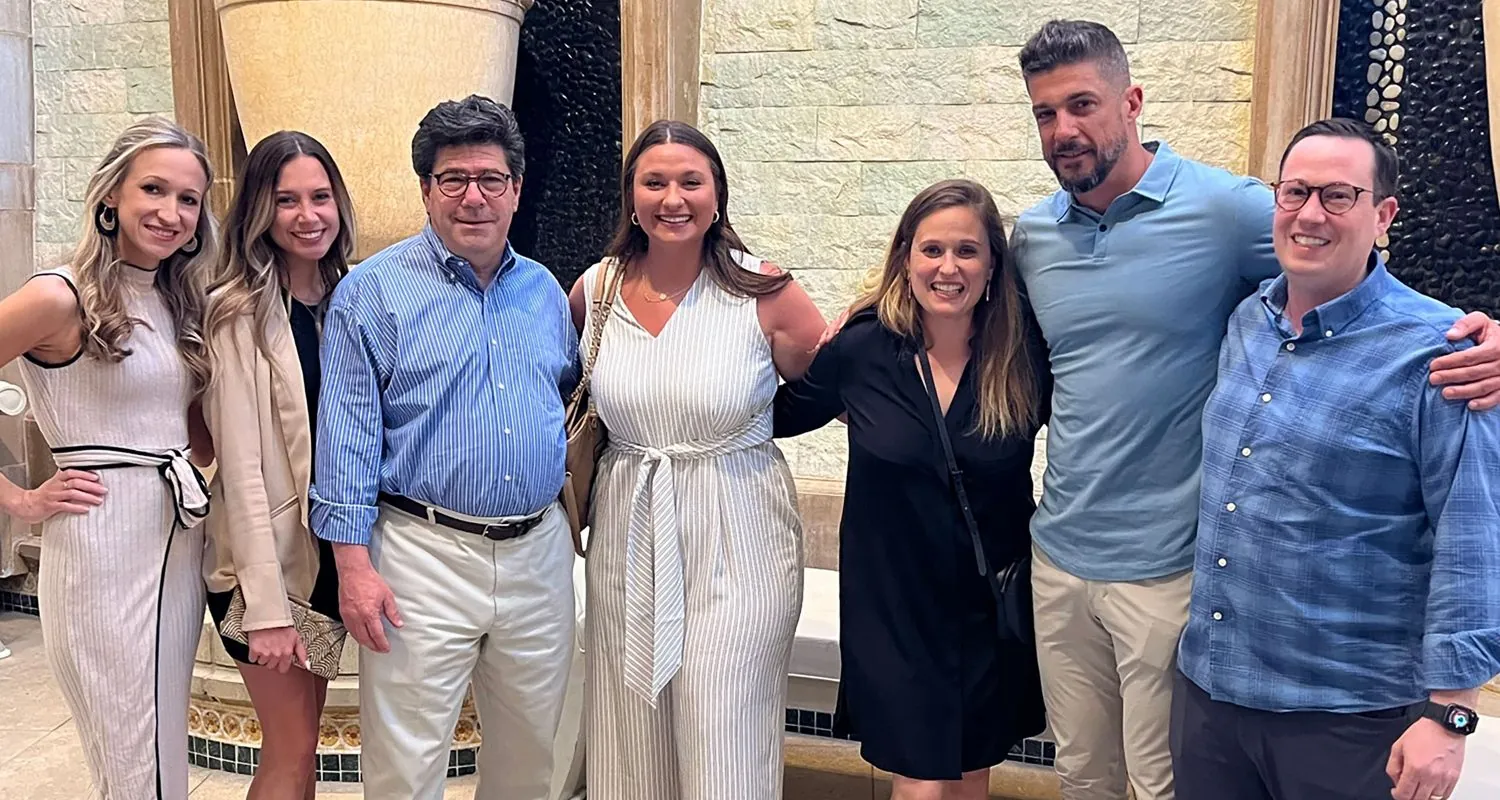 Linear team standing together looking at the camera.