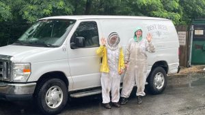 photo of Best Bees beekeepers in front of van waving