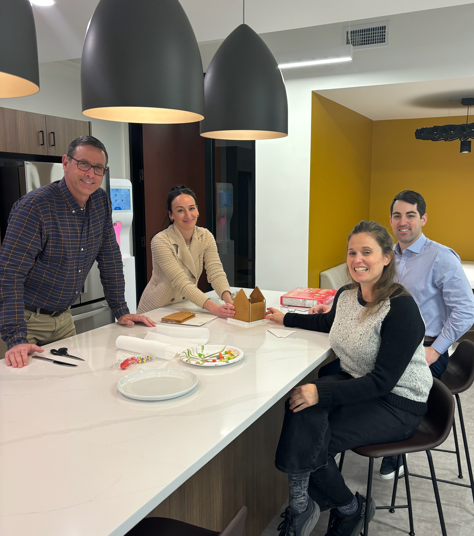 Aubrey, Tasha, Matt, and Lauren R making a gingerbread house